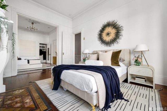 a bedroom with a bed and a chandelier