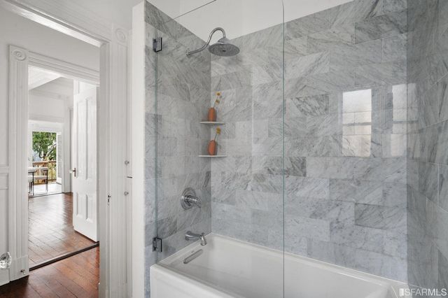 a bathroom with a bathtub and shower