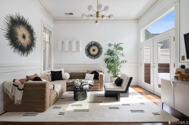 a living room with furniture and a floor to ceiling window