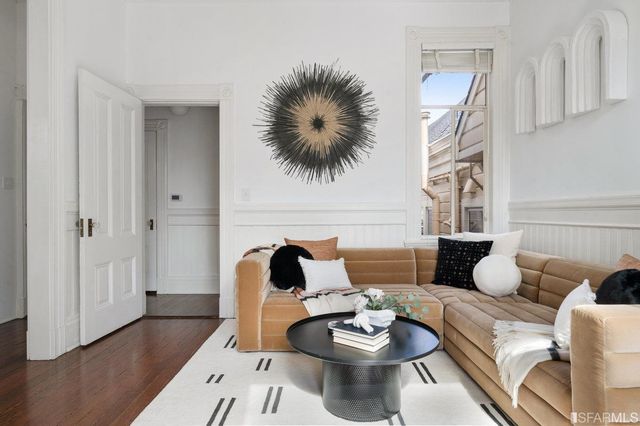 a living room with furniture and wooden floor