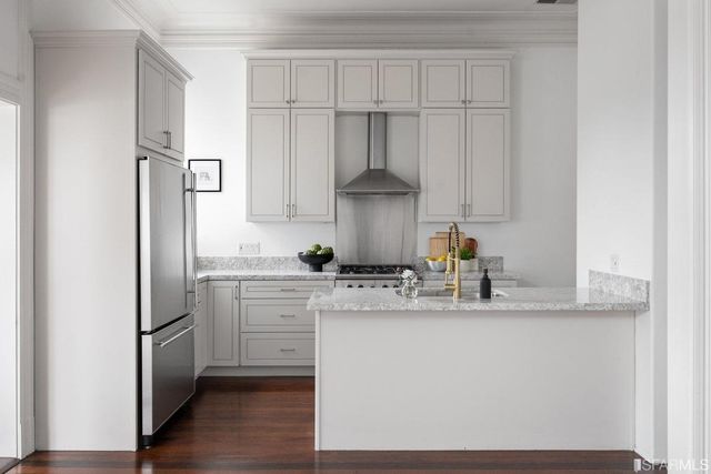 a kitchen with kitchen island granite countertop white cabinets and white appliances