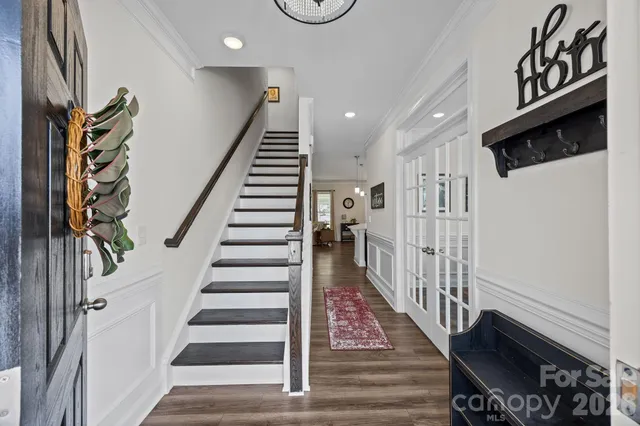 a view of entryway with stairs and wooden floor