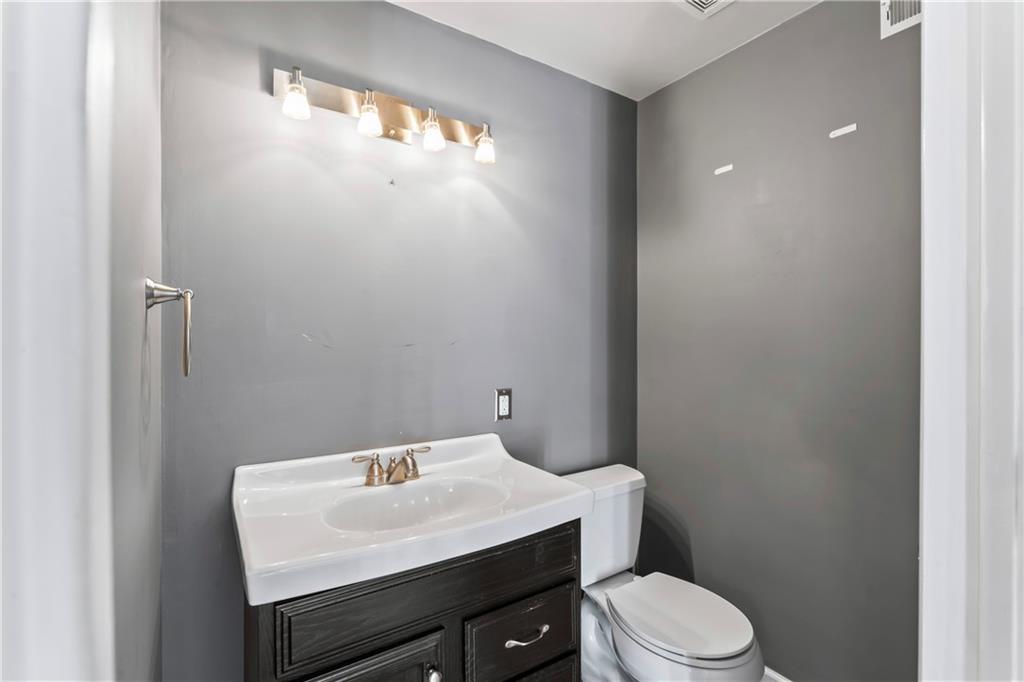 615 Midway Drive Beaver, PA 15009 - Photo 13 of 30 a white toilet sitting next to a bathroom sink