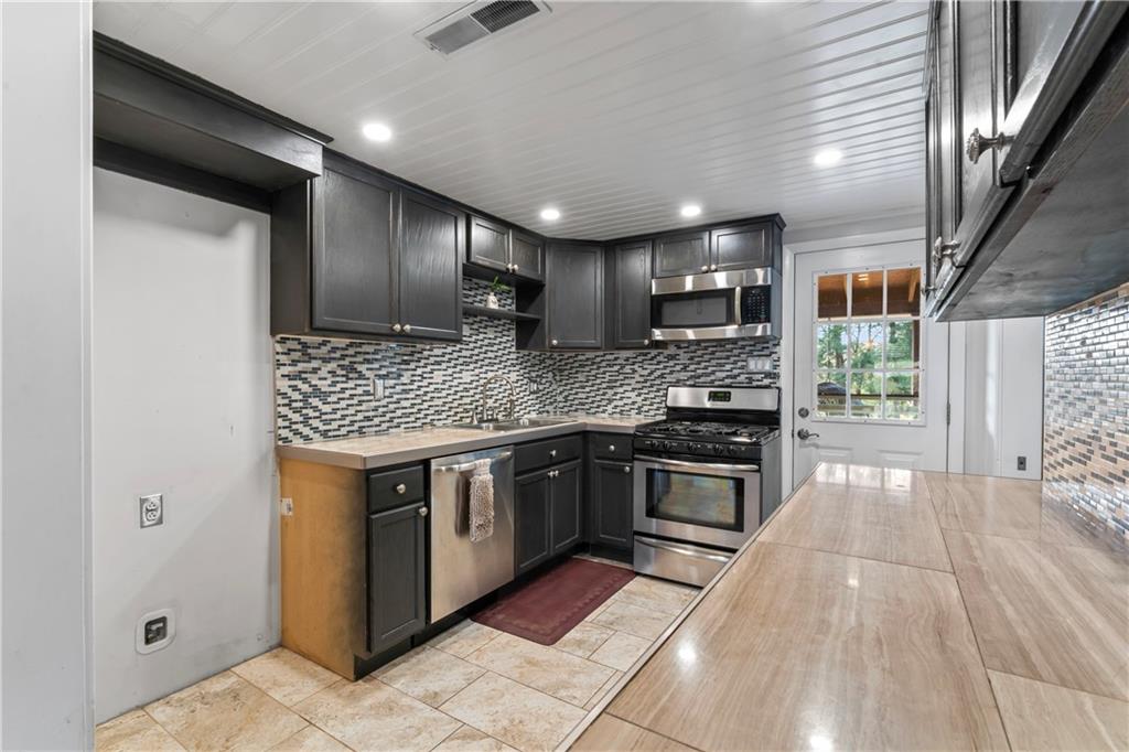 615 Midway Drive Beaver, PA 15009 - Photo 6 of 30 a kitchen with stainless steel appliances granite countertop a sink stove and refrigerator