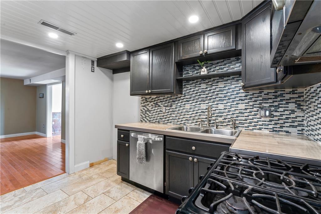 615 Midway Drive Beaver, PA 15009 - Photo 7 of 30 a kitchen with granite countertop a stove and cabinets