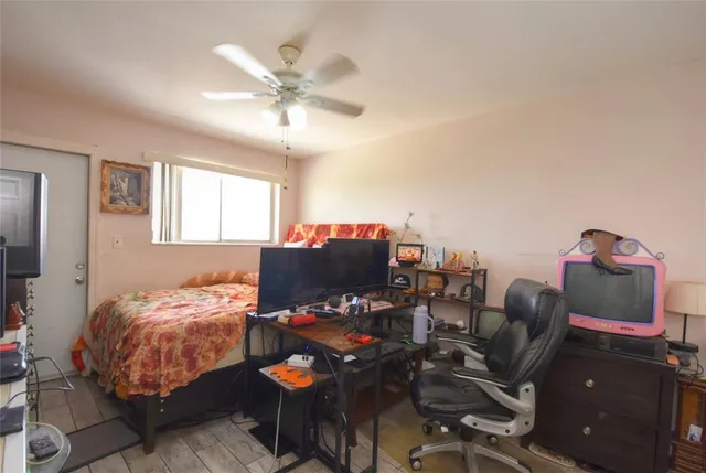 a bedroom with bed and a chandelier