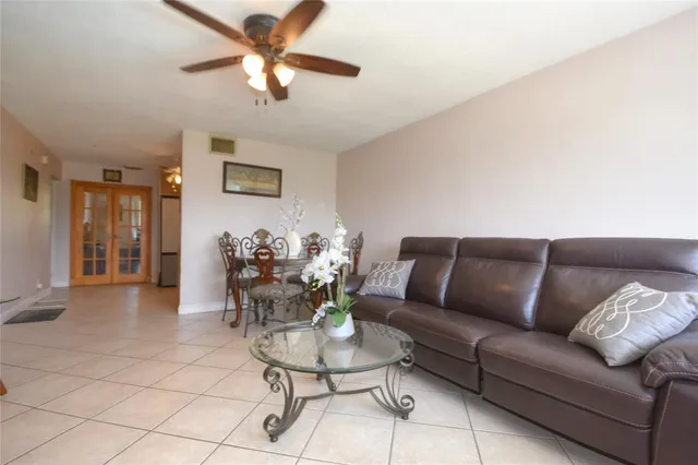 a living room with furniture and a ceiling fan