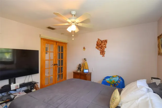 a bedroom with a bed and a flat screen tv