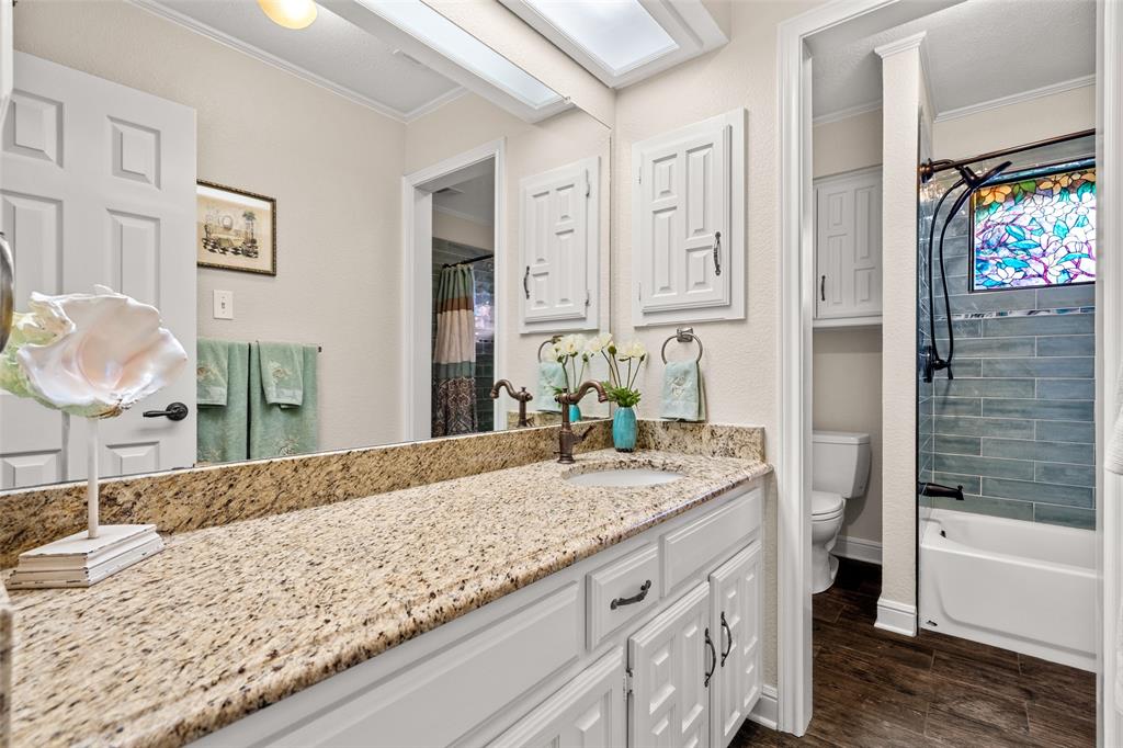 400 Hunters Ridge Circle Coppell, TX 75019 - Photo 23 of 35 a bathroom with a granite countertop sink and a mirror