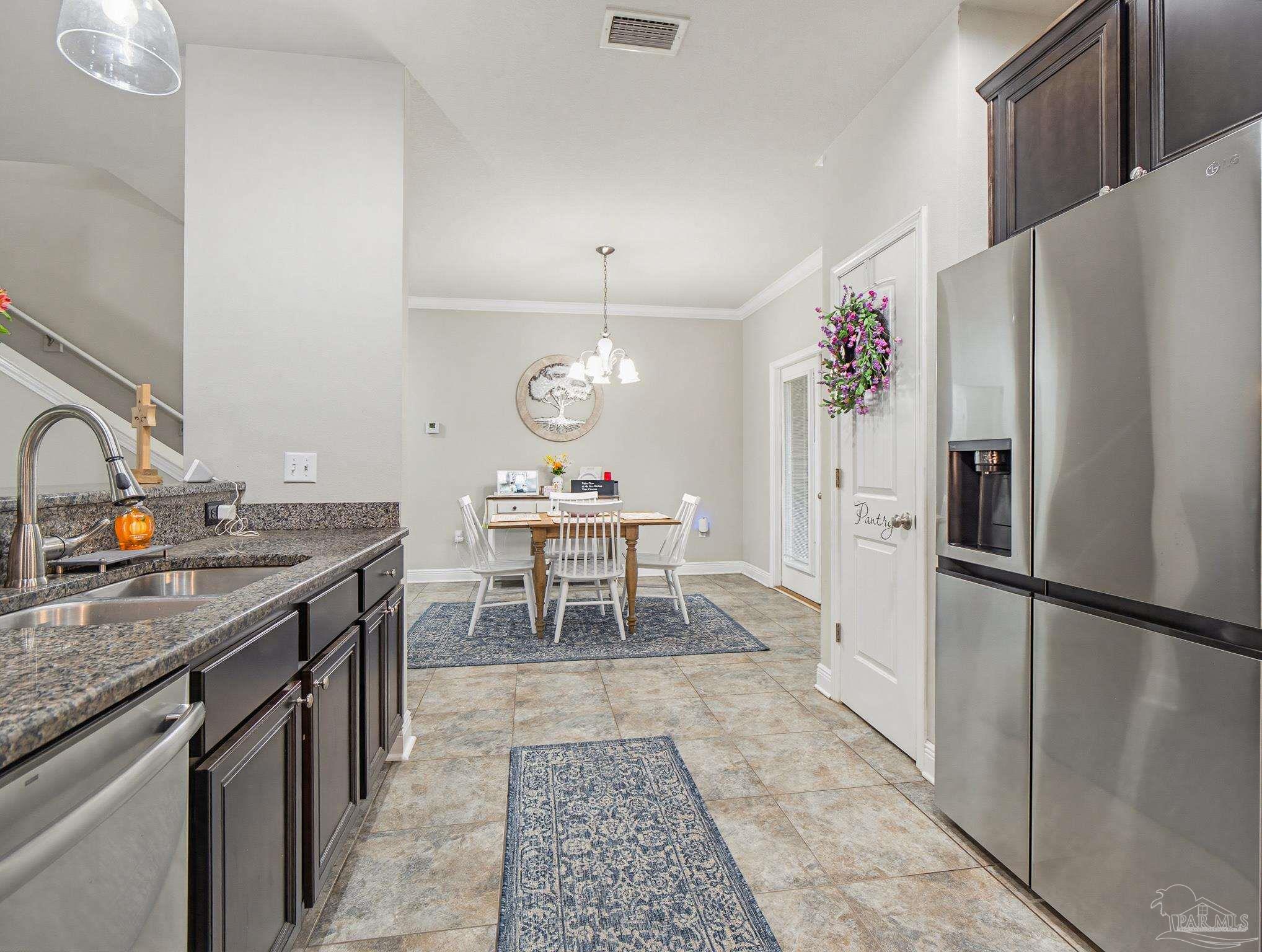 6294 Ladera Trail Pace, FL 32571 - Photo 12 of 50 a kitchen with a refrigerator and a sink