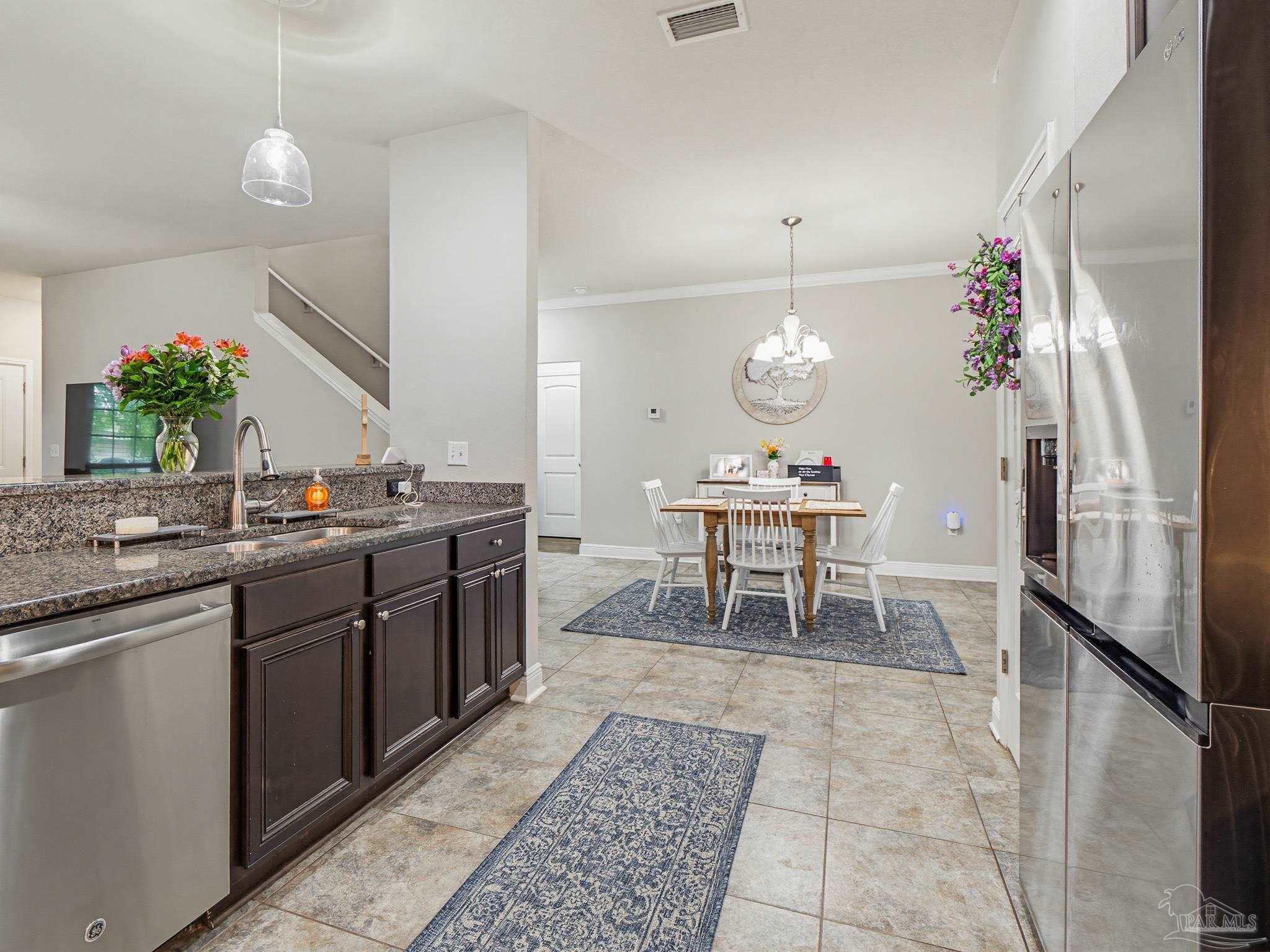 6294 Ladera Trail Pace, FL 32571 - Photo 13 of 50 a kitchen with a dining table and chairs
