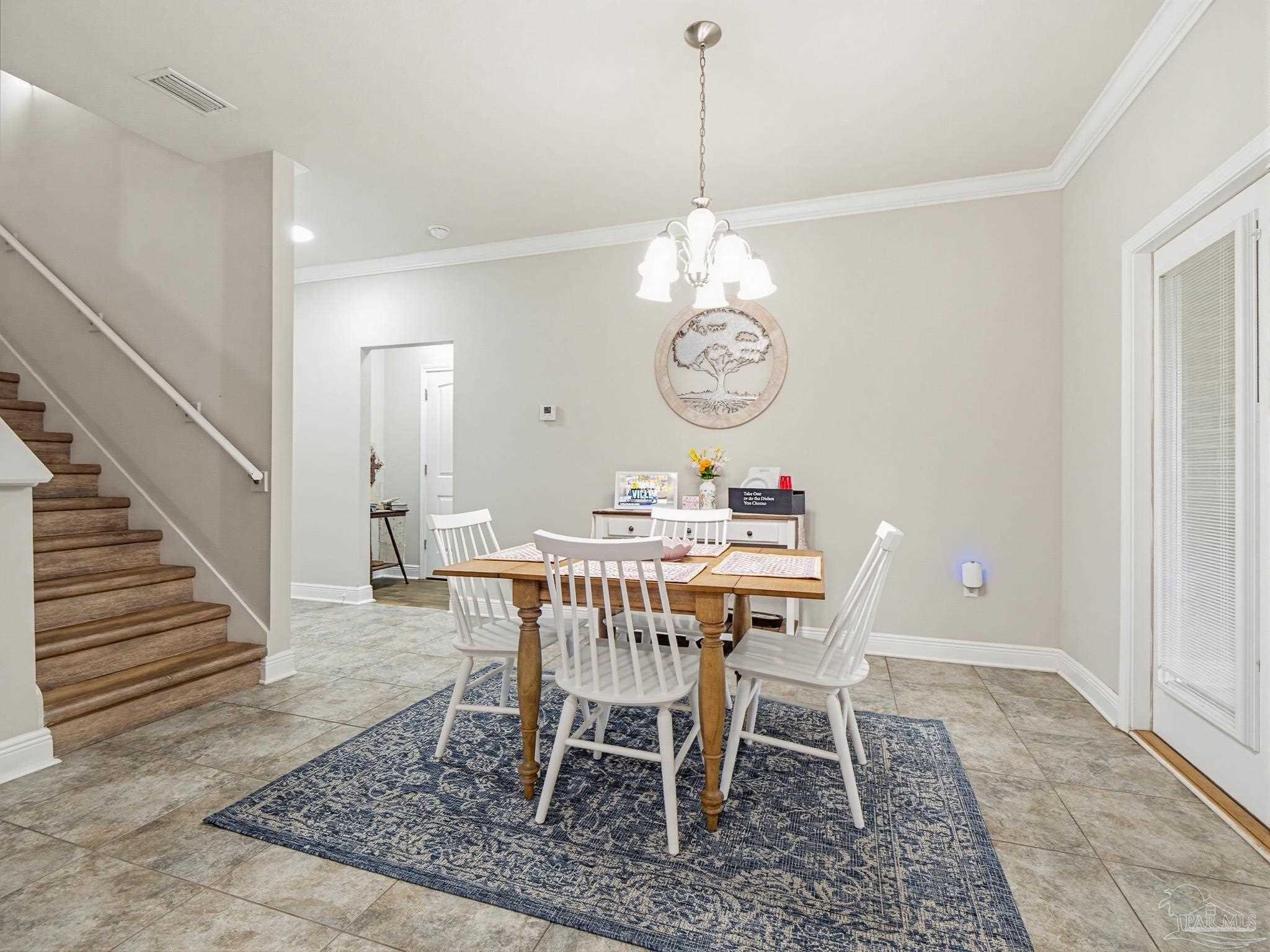 6294 Ladera Trail Pace, FL 32571 - Photo 14 of 50 a dining room with a dining table a chandelier and a dining table