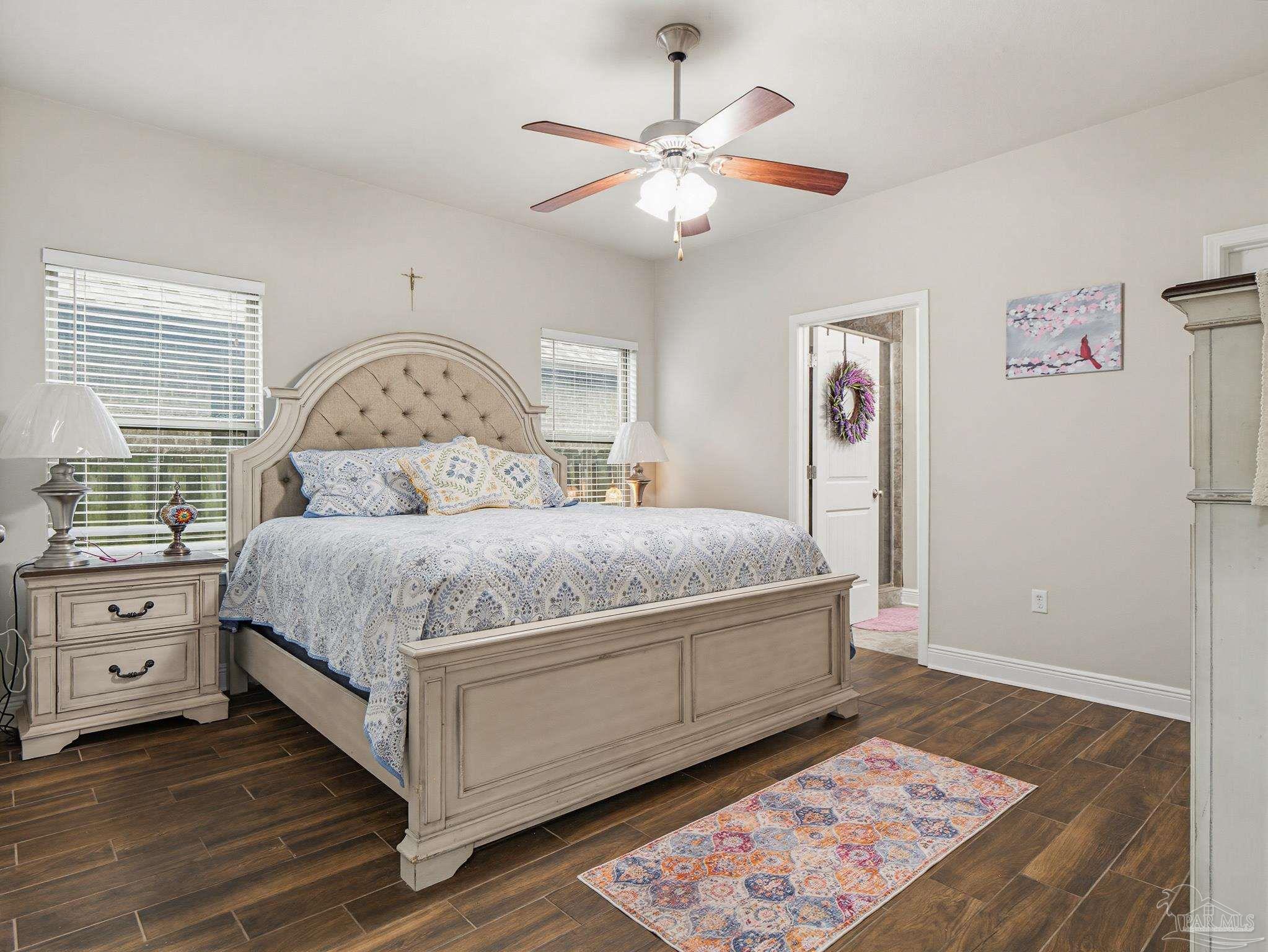 6294 Ladera Trail Pace, FL 32571 - Photo 17 of 50 a bedroom with a large bed and a chandelier