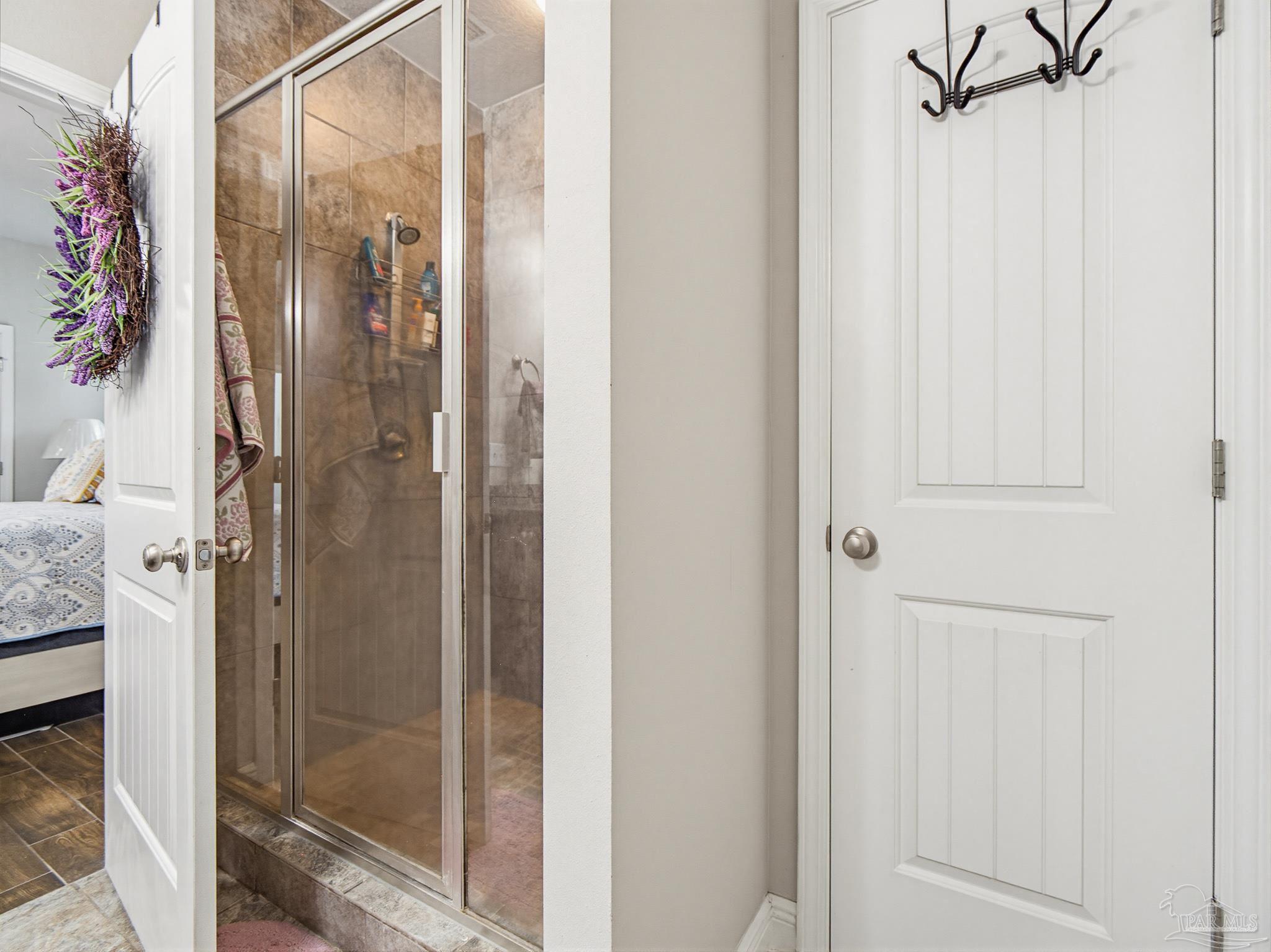 6294 Ladera Trail Pace, FL 32571 - Photo 20 of 50 a bathroom with a glass shower door