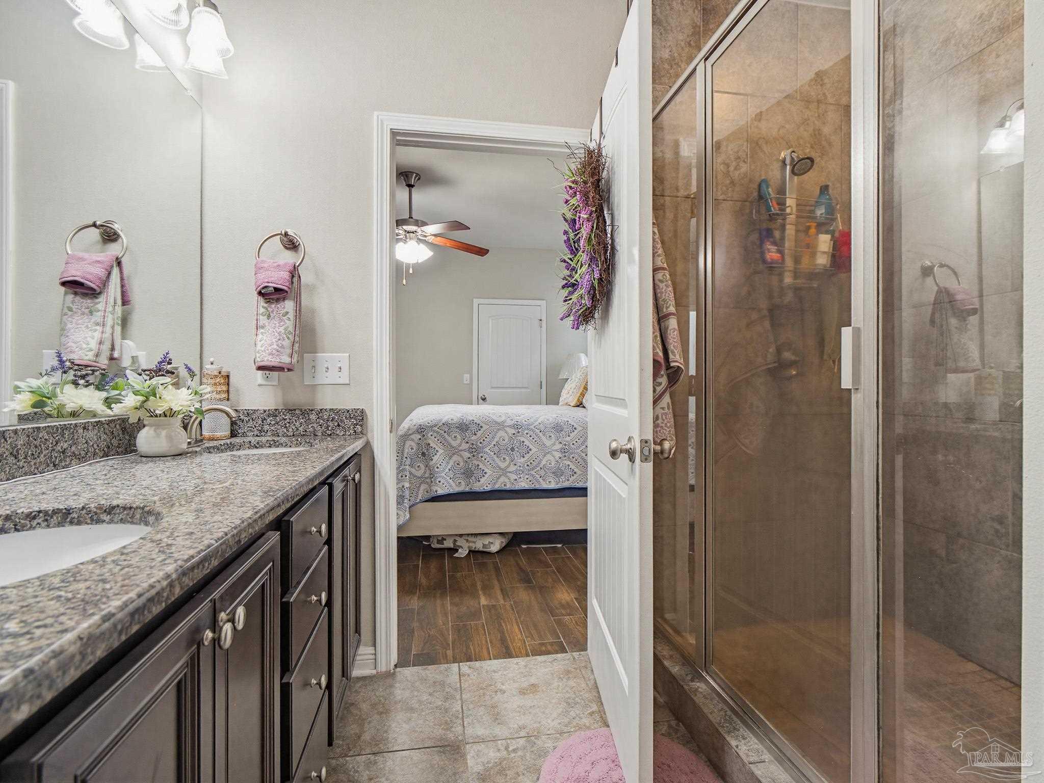 6294 Ladera Trail Pace, FL 32571 - Photo 21 of 50 a bathroom with a granite countertop shower a sink and mirror