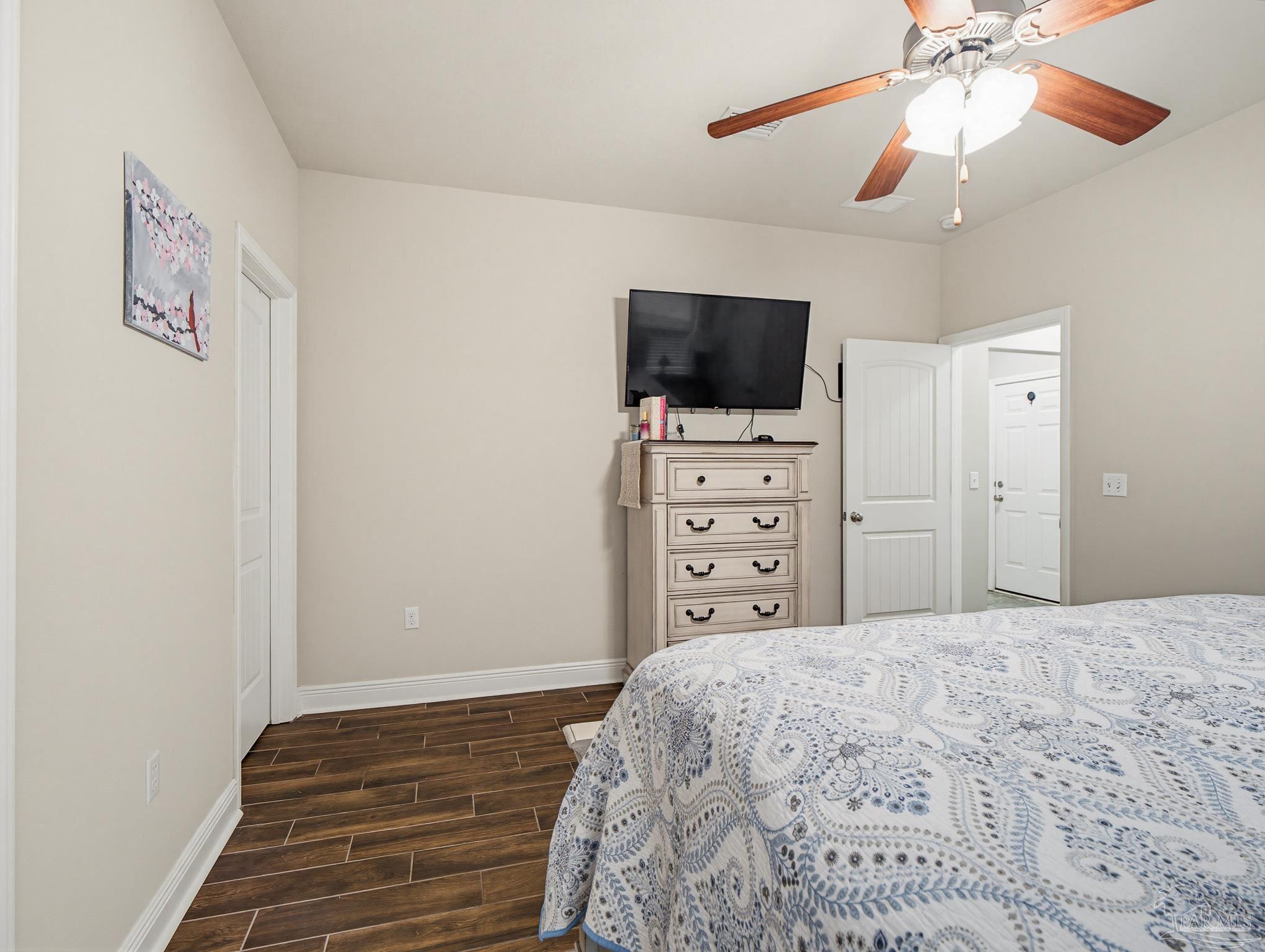 6294 Ladera Trail Pace, FL 32571 - Photo 22 of 50 a bedroom with a bed and a flat screen tv