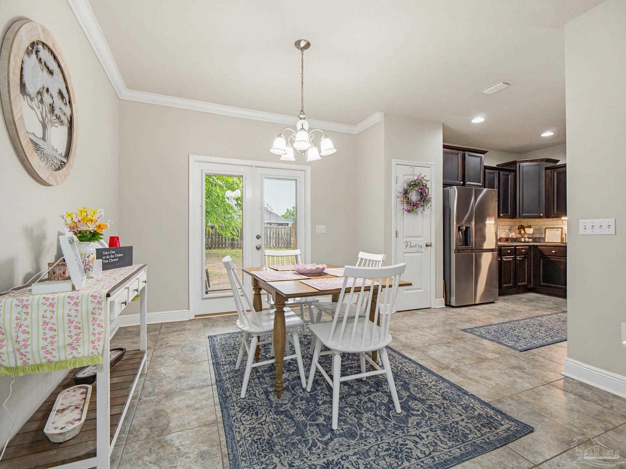 6294 Ladera Trail Pace, FL 32571 - Photo 24 of 50 a view of a dining room with furniture and a chandelier