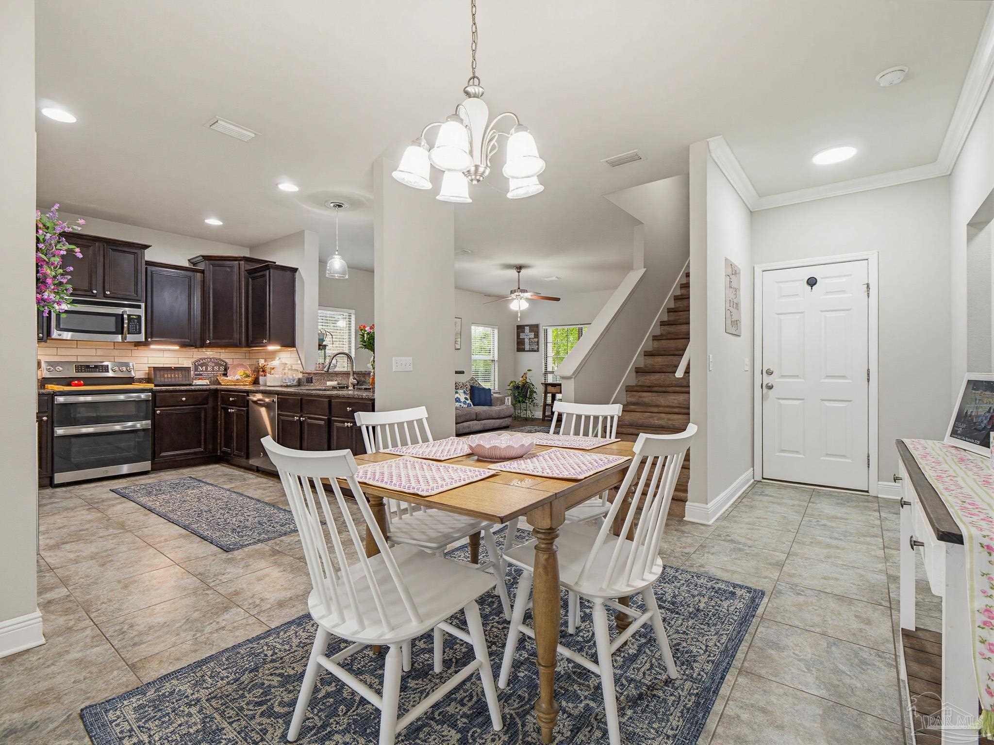 6294 Ladera Trail Pace, FL 32571 - Photo 25 of 50 a view of a dining room with furniture and wooden floor
