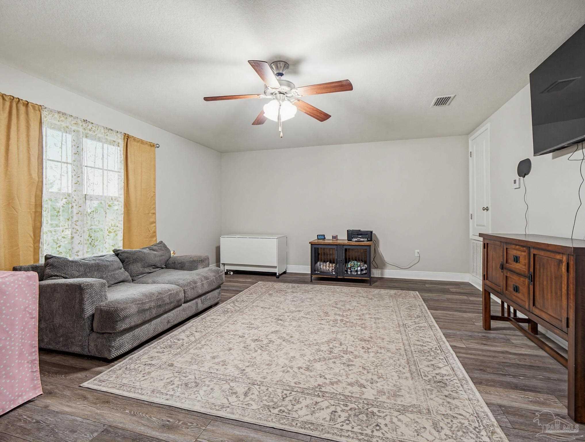 6294 Ladera Trail Pace, FL 32571 - Photo 27 of 50 a living room with furniture and a flat screen tv