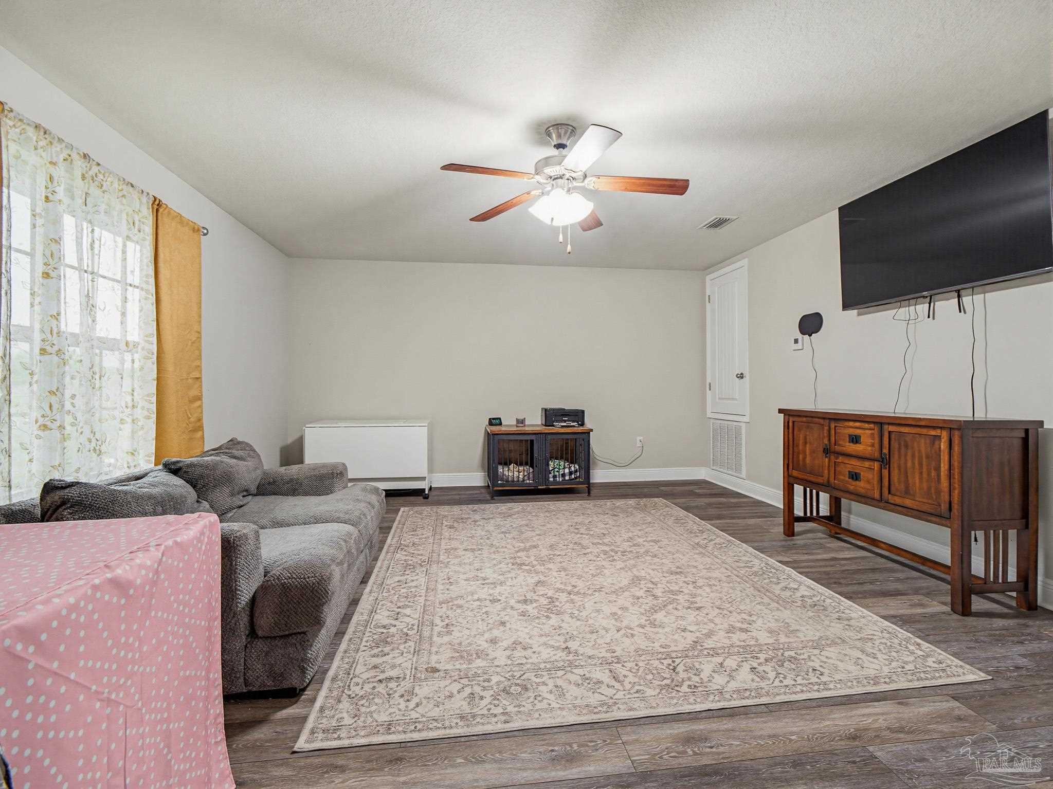 6294 Ladera Trail Pace, FL 32571 - Photo 28 of 50 a living room with furniture and a flat screen tv