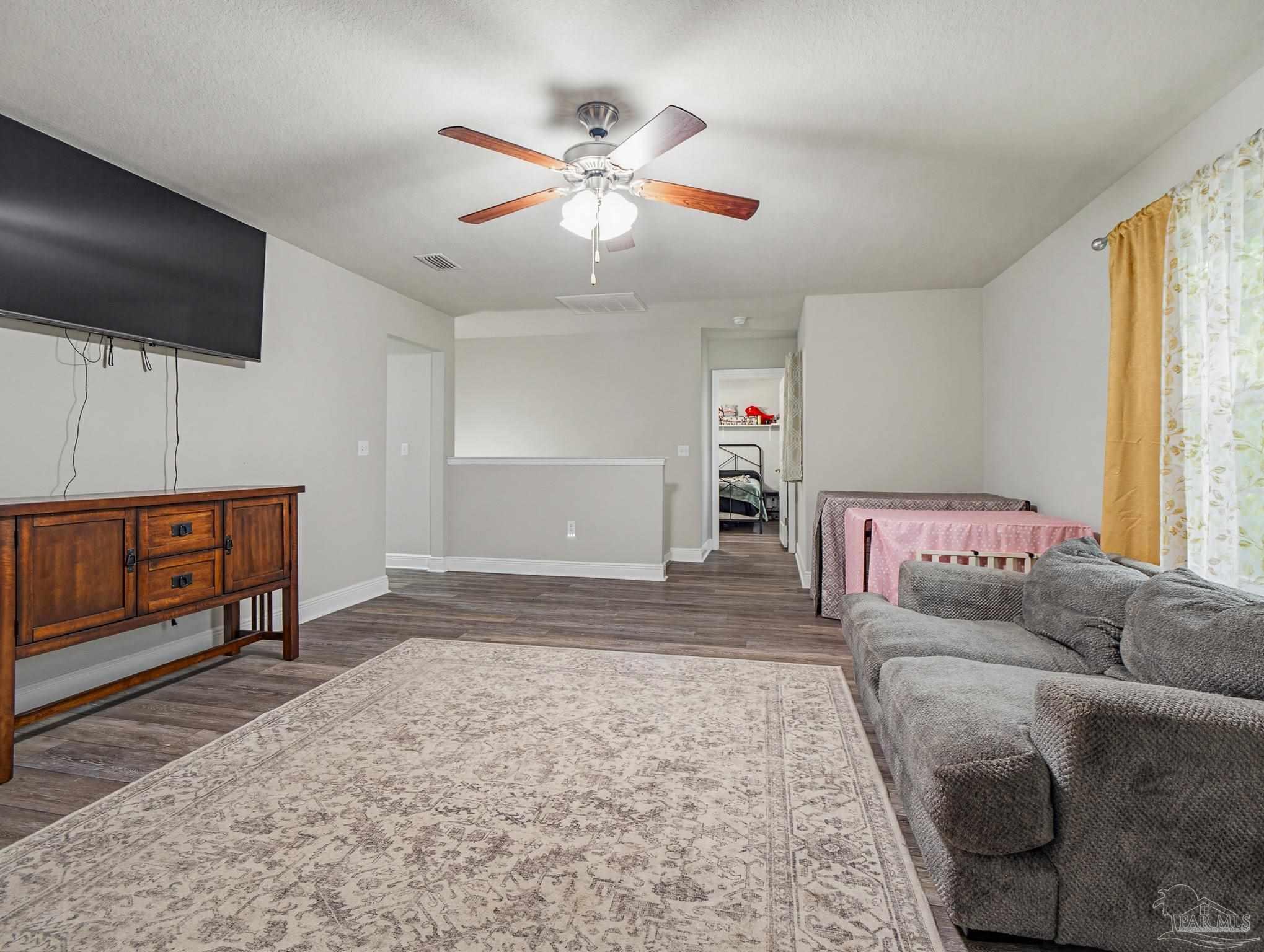6294 Ladera Trail Pace, FL 32571 - Photo 29 of 50 a living room with furniture and a flat screen tv