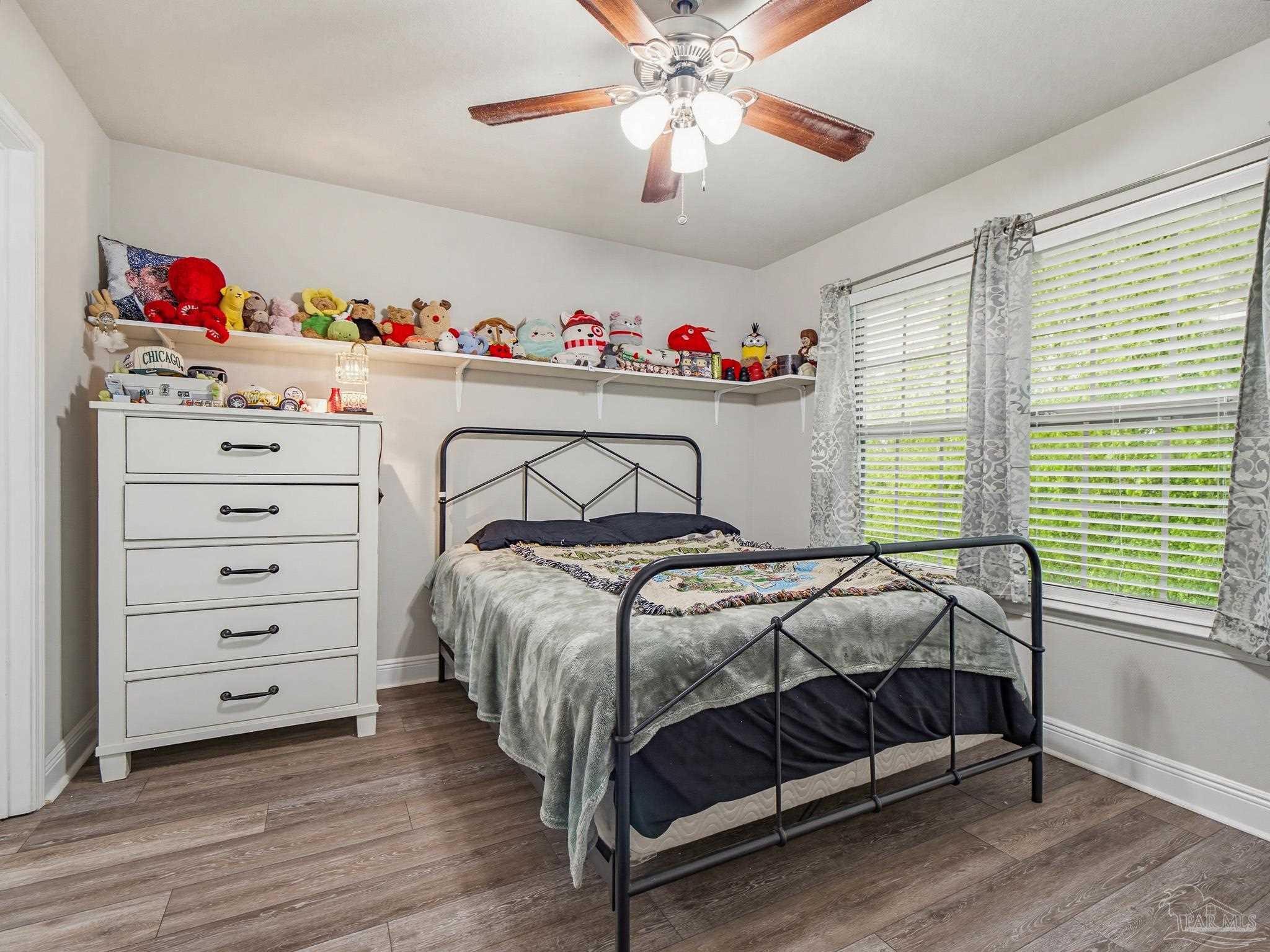 6294 Ladera Trail Pace, FL 32571 - Photo 32 of 50 a bedroom with a bed and wooden floor