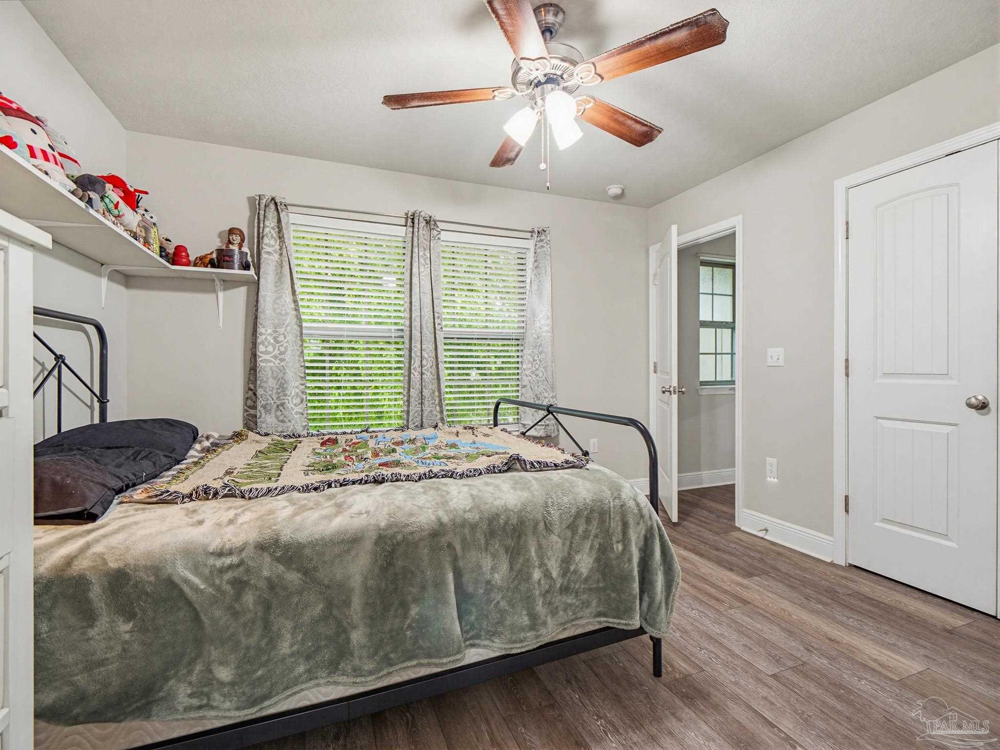 6294 Ladera Trail Pace, FL 32571 - Photo 33 of 50 a bedroom with a bed and a chandelier