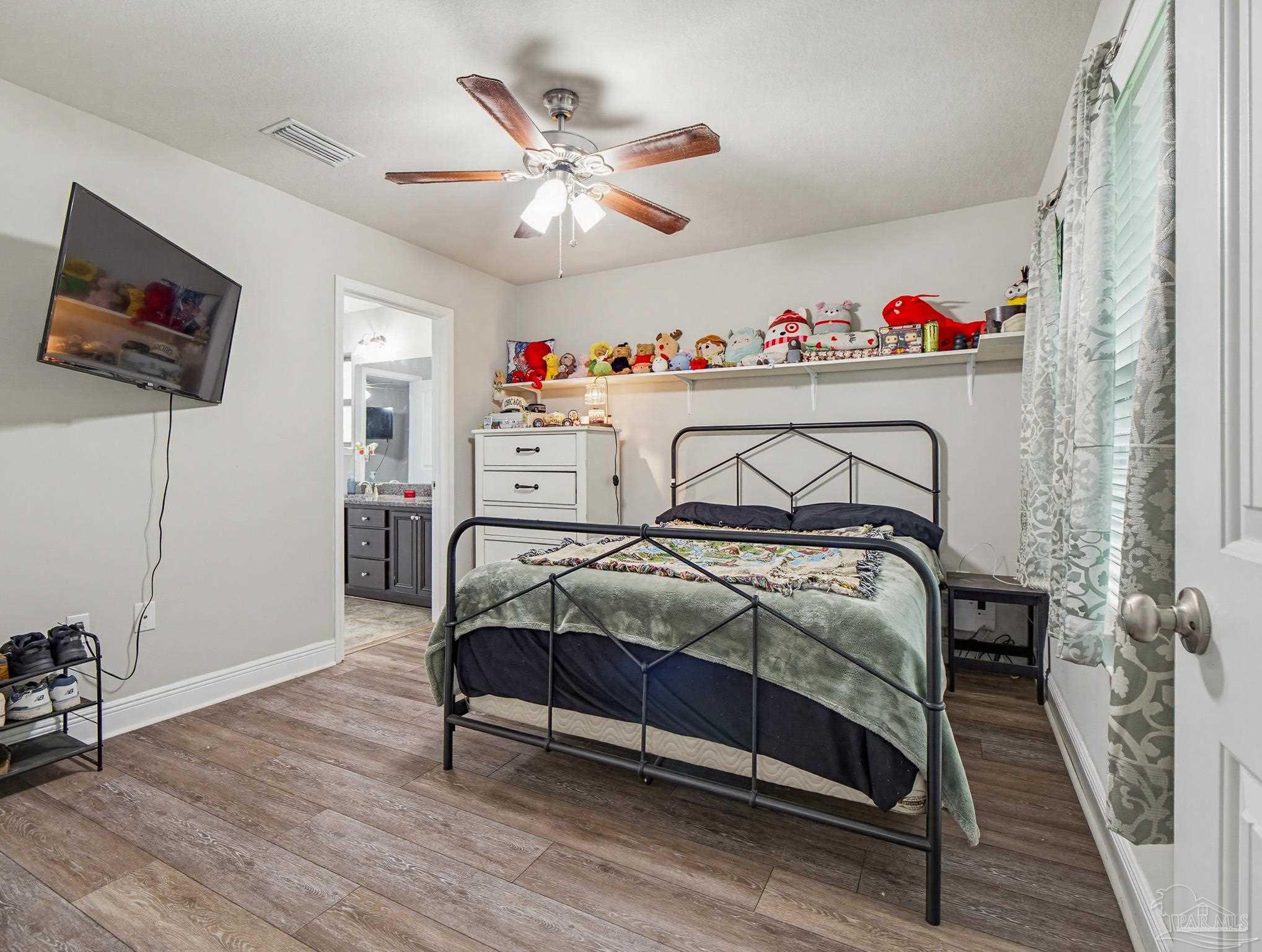6294 Ladera Trail Pace, FL 32571 - Photo 34 of 50 a bedroom with a bed and a chandelier