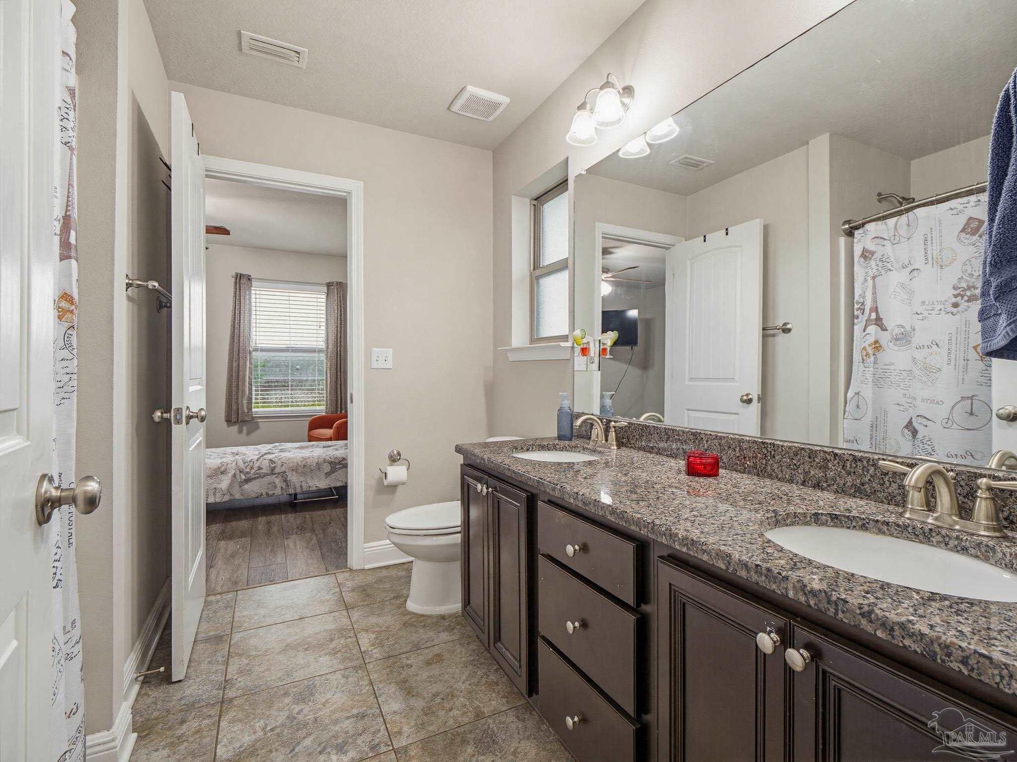 6294 Ladera Trail Pace, FL 32571 - Photo 35 of 50 a spacious bathroom with a granite countertop double vanity sink a mirror and a shower