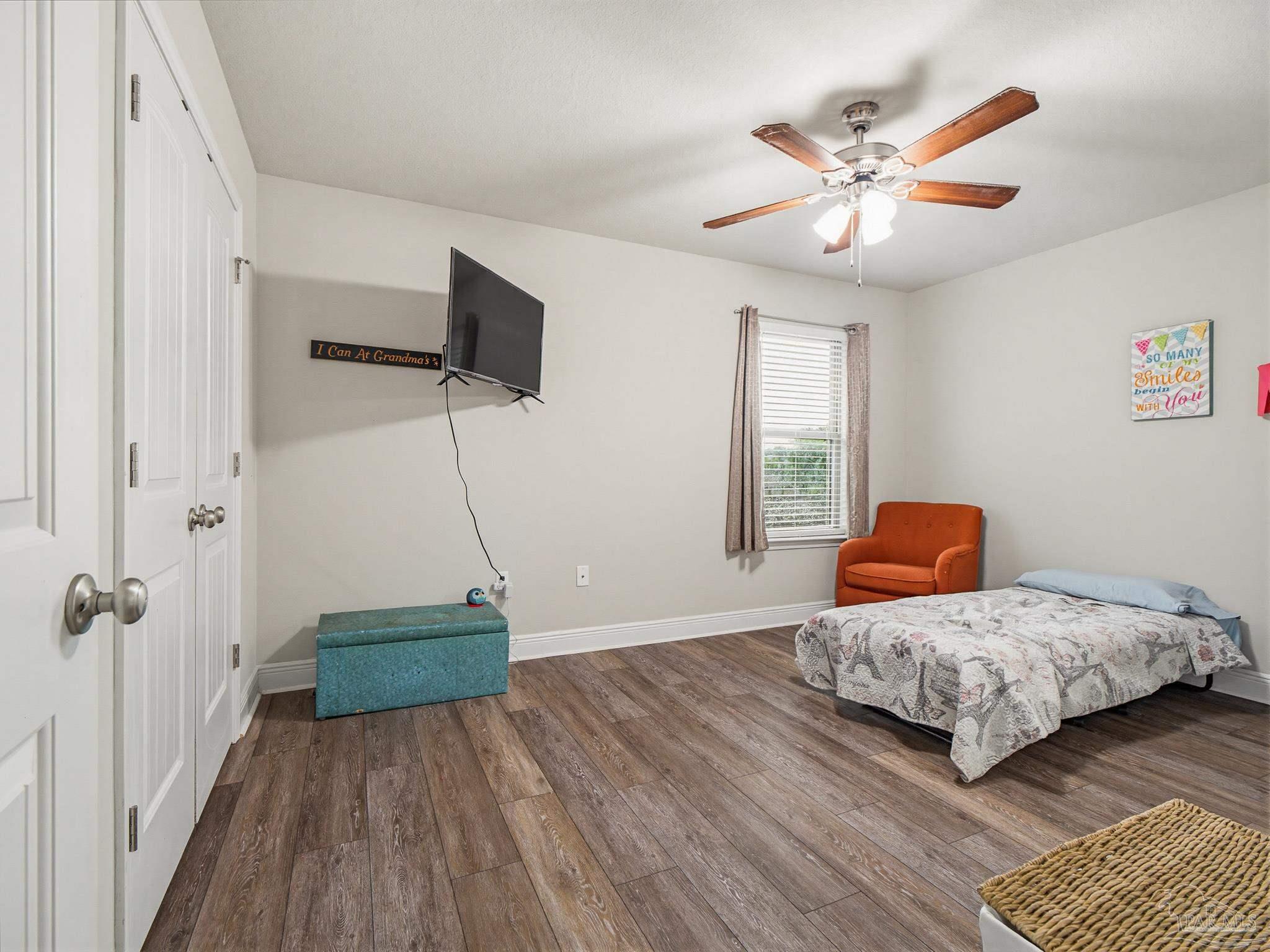 6294 Ladera Trail Pace, FL 32571 - Photo 37 of 50 a bedroom with a bed and a chandelier