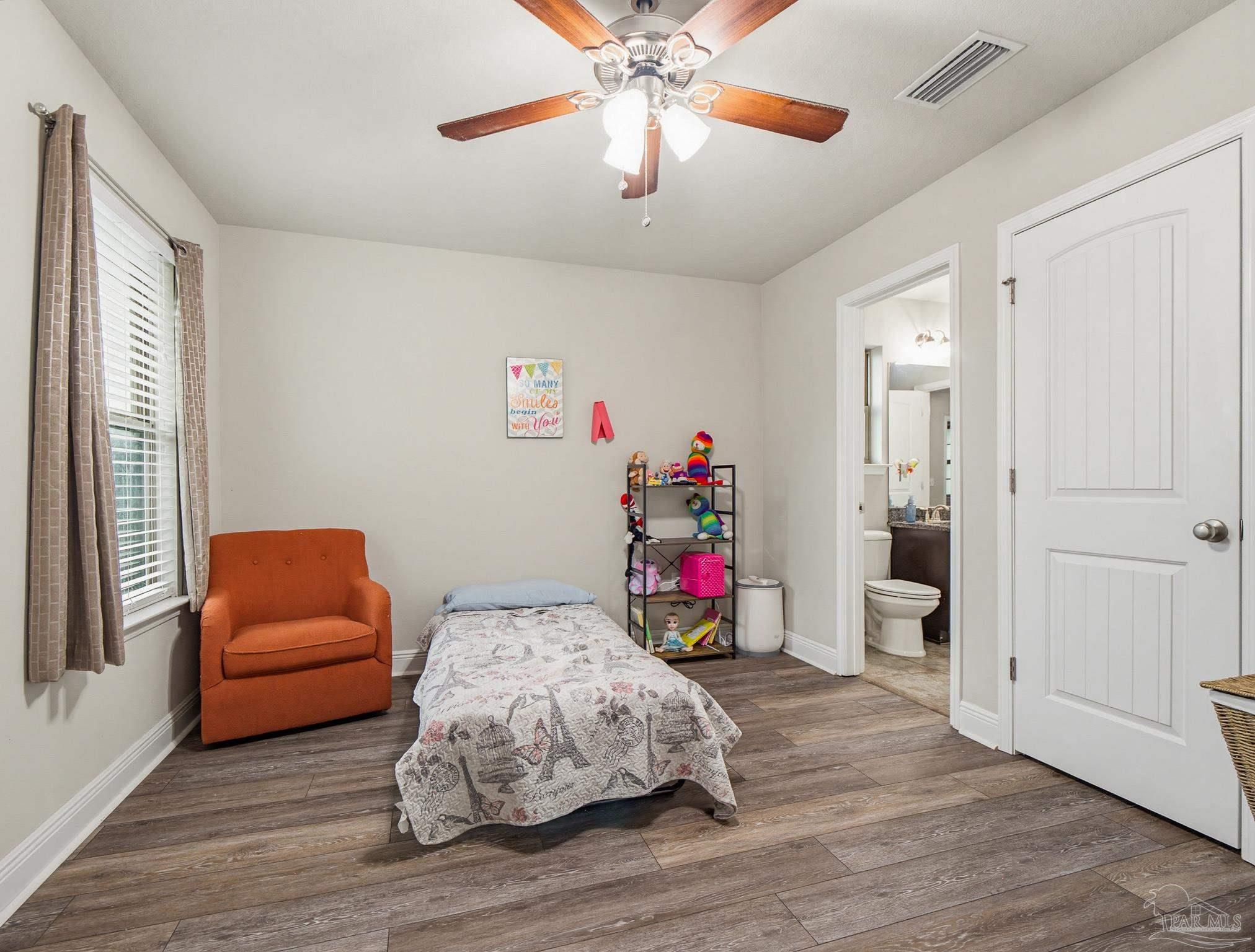 6294 Ladera Trail Pace, FL 32571 - Photo 38 of 50 a bedroom with furniture and a wooden floor