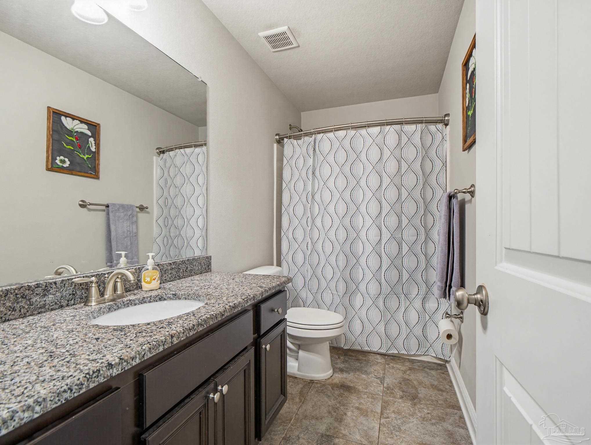 6294 Ladera Trail Pace, FL 32571 - Photo 43 of 50 a bathroom with a granite countertop sink toilet and shower