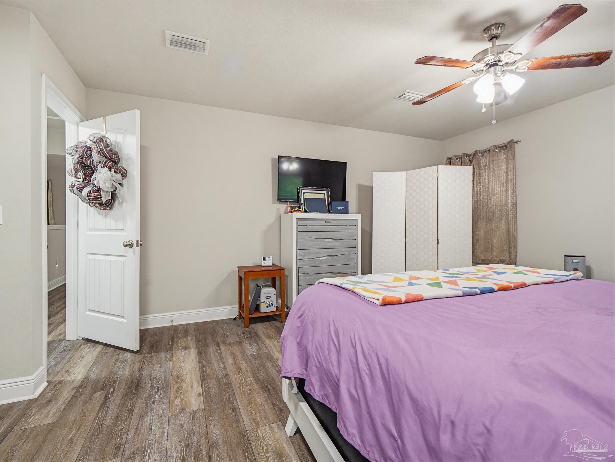 6294 Ladera Trail Pace, FL 32571 - Photo 47 of 50 a bedroom with a bed and a flat screen tv