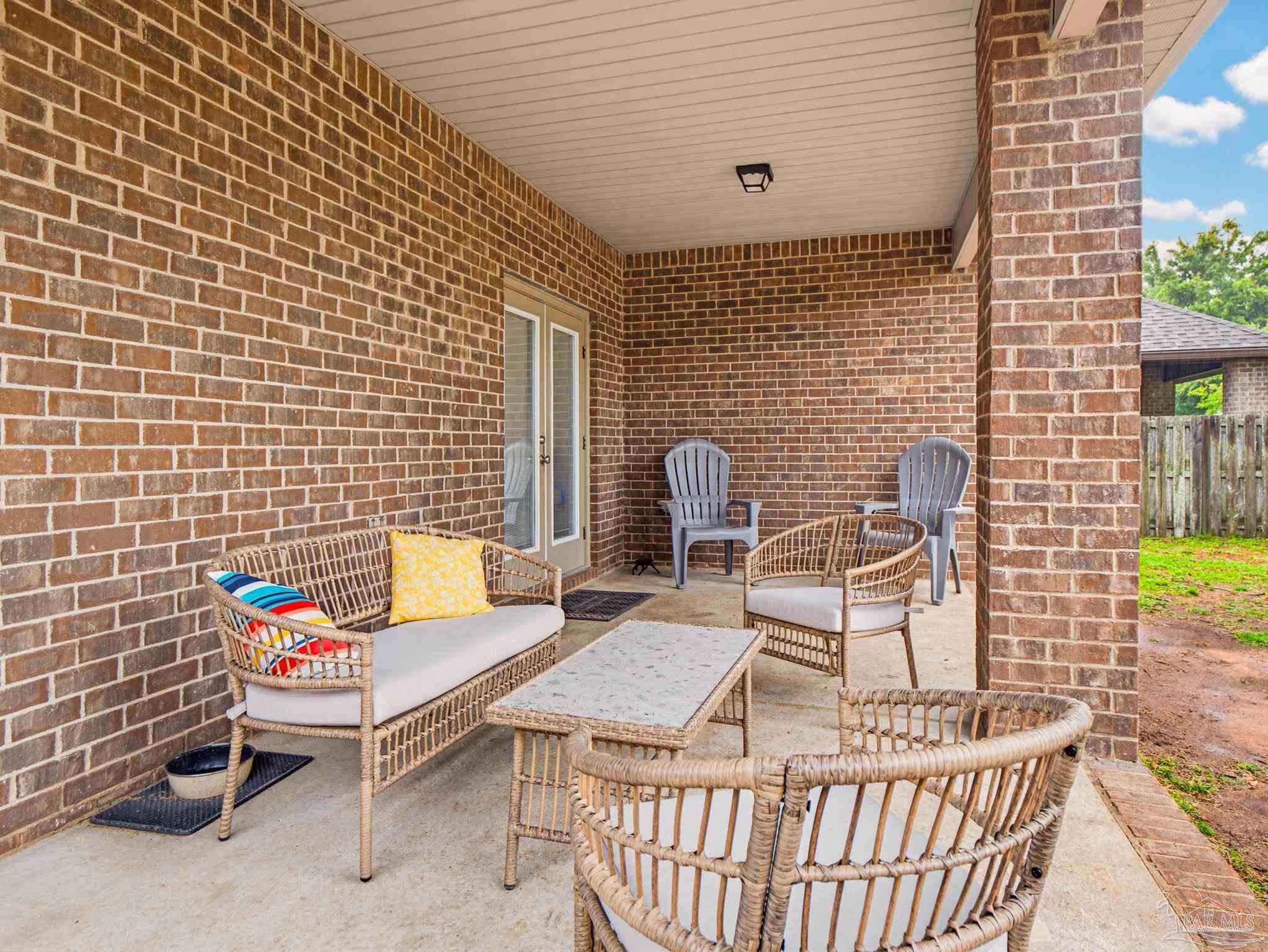 6294 Ladera Trail Pace, FL 32571 - Photo 49 of 50 a chairs and a table in a patio