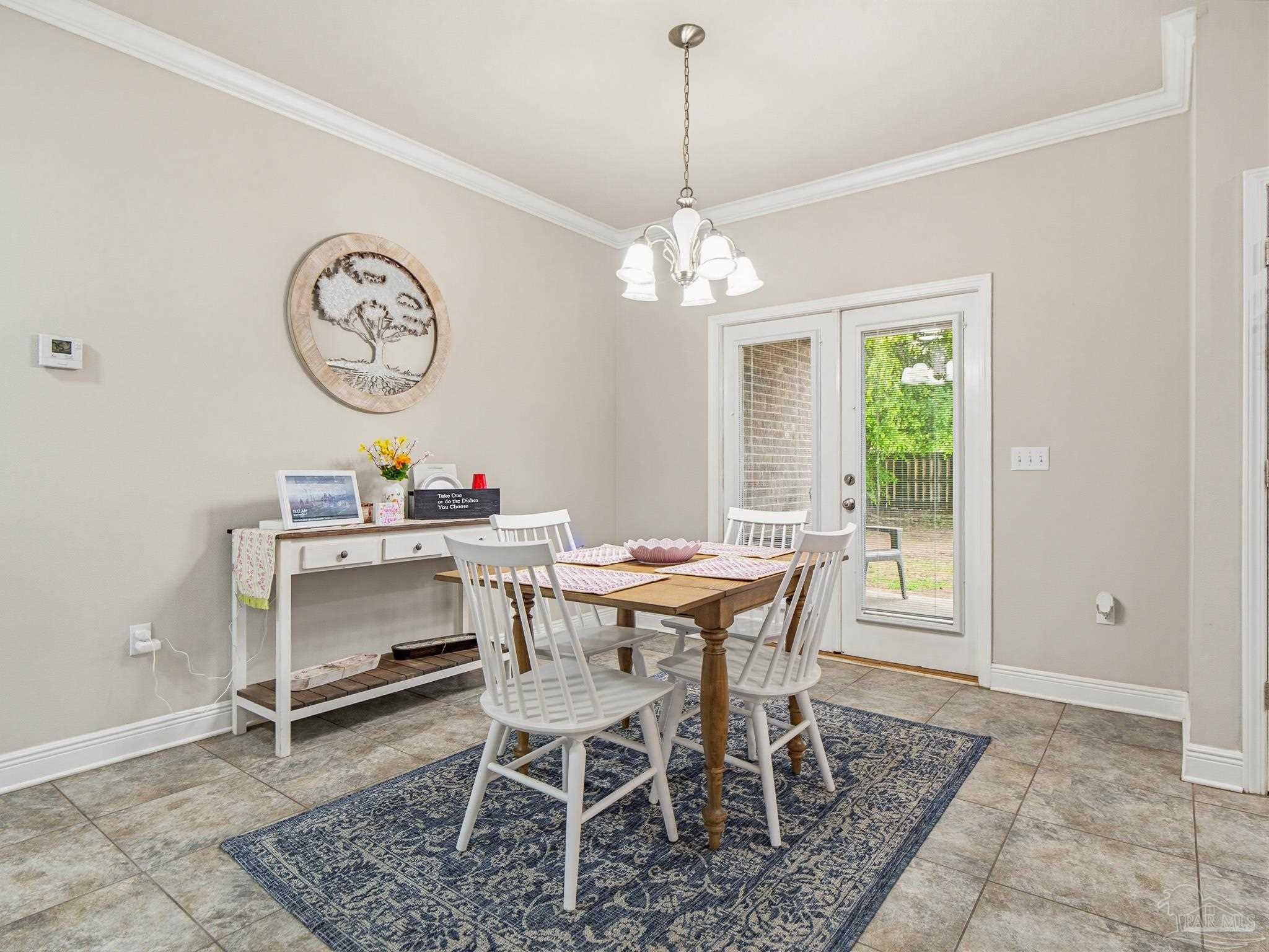6294 Ladera Trail Pace, FL 32571 - Photo 9 of 50 a dining room with wooden floor and a chandelier