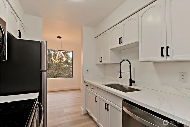 a kitchen with a refrigerator and a sink