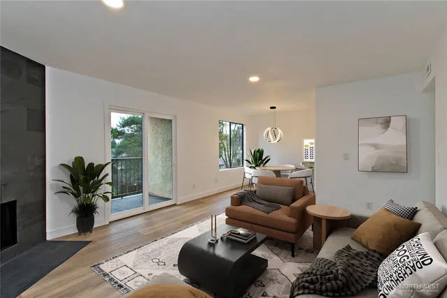 a living room with furniture and wooden floor