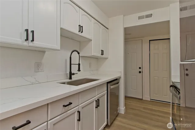 a kitchen with stainless steel appliances a sink stove and refrigerator