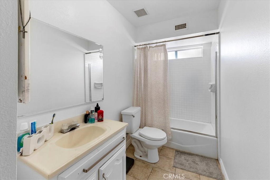 1128 South Parton Street Santa Ana, CA 92707 - Photo 14 of 32 a white toilet sitting next to a bathroom sink