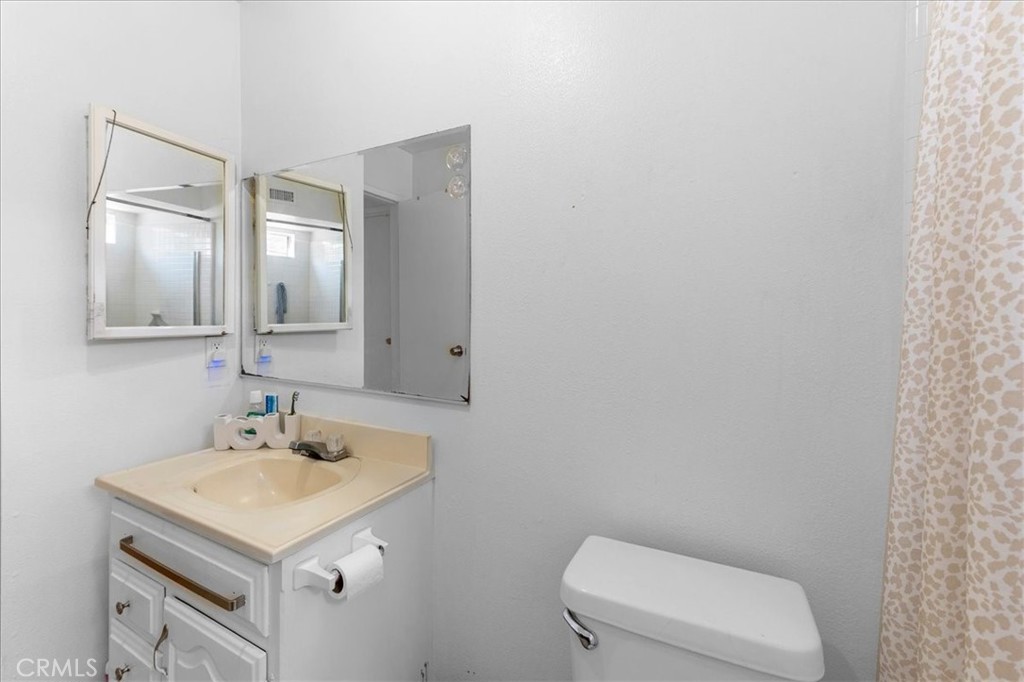 1128 South Parton Street Santa Ana, CA 92707 - Photo 15 of 32 a bathroom with a sink a toilet and mirror