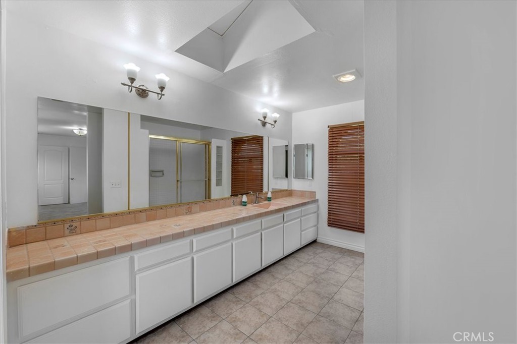 1128 South Parton Street Santa Ana, CA 92707 - Photo 21 of 32 a spacious bathroom with a granite countertop sink mirror and a