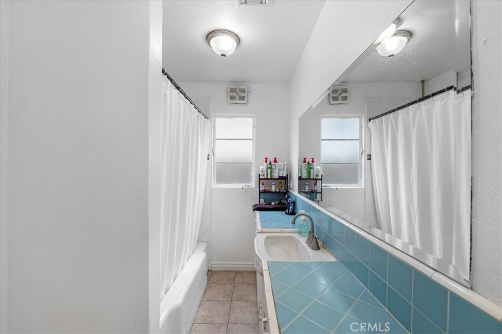 1128 South Parton Street Santa Ana, CA 92707 - Photo 24 of 32 a spacious bathroom with a tub a mirror and a shower