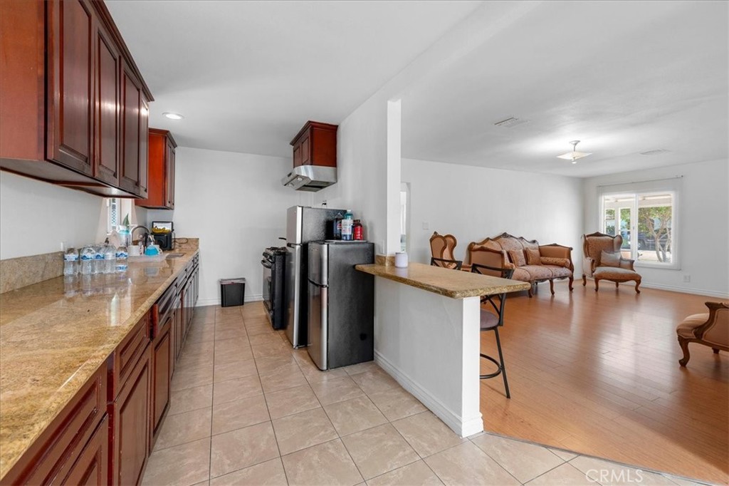 1128 South Parton Street Santa Ana, CA 92707 - Photo 9 of 32 a kitchen with refrigerator and cabinets