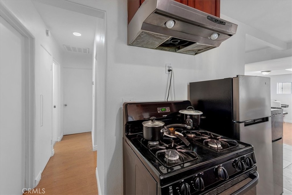 1128 South Parton Street Santa Ana, CA 92707 - Photo 10 of 32 a kitchen with a stove and a refrigerator
