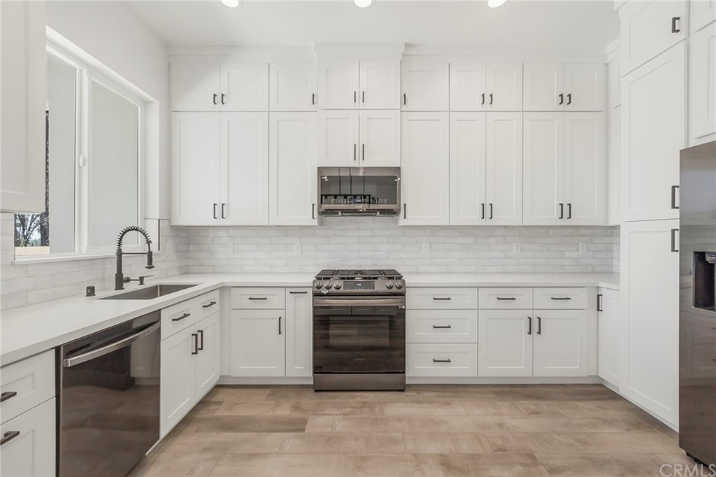 1830 Apple View Way Paradise, CA 95969 - Photo 20 of 75 a white kitchen with granite countertop white cabinets