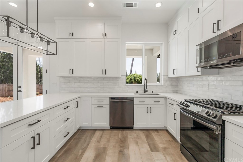 1830 Apple View Way Paradise, CA 95969 - Photo 21 of 75 a kitchen with granite countertop cabinets stainless steel appliances and a sink