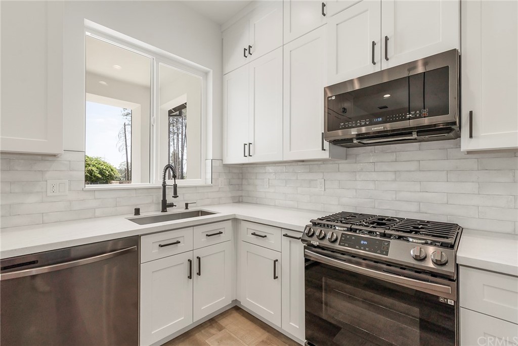 1830 Apple View Way Paradise, CA 95969 - Photo 22 of 75 a kitchen with stainless steel appliances a sink a stove a microwave cabinets and a window
