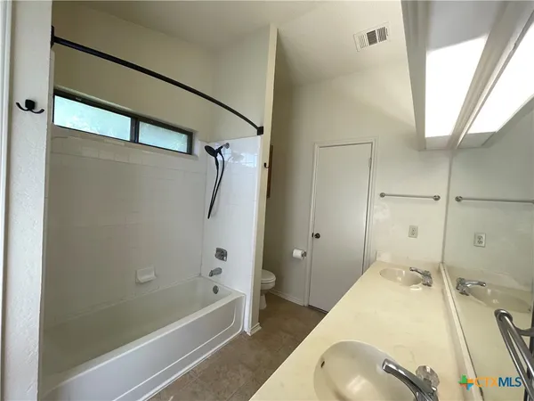 a bathroom with a tub and a shower