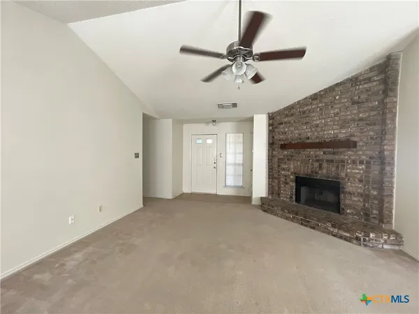 a view of an empty room with a fireplace