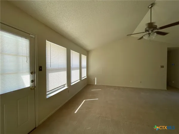 a view of an empty room with a window